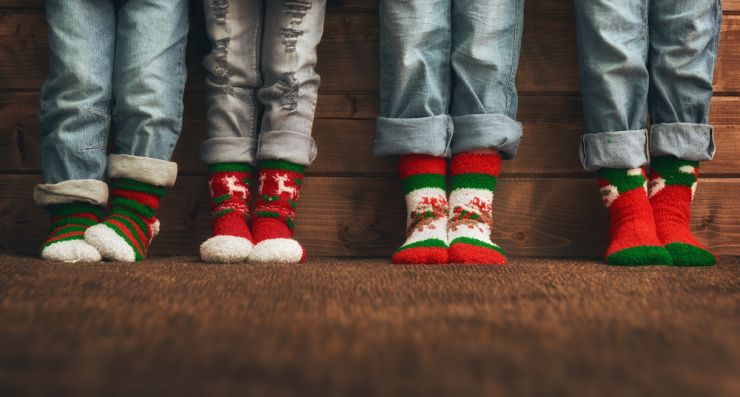 Four children wearing Christmas socks
