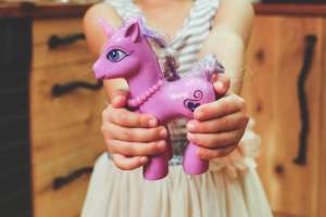 Girl with purple toy horse