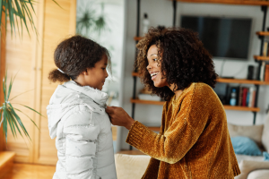 Mother and daughter getting ready to go outside