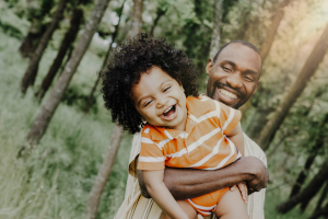 Dad and child hugging and smiling