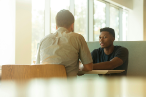 Two men talking over a table