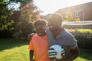 Father and son playing football