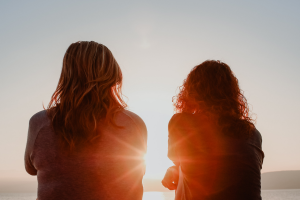 Two women lying talking