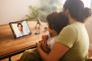 Mum and child facetiming the dad