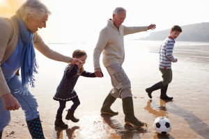 Grandparents with children on the beach