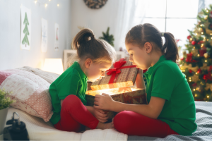 Two children opening presents