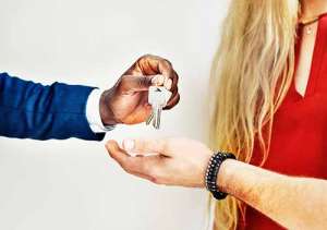 Two people handing over keys
