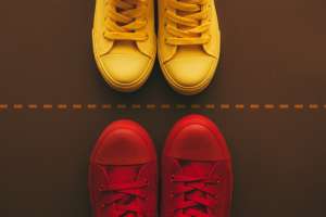Red and yellow shoes on side of dotted line